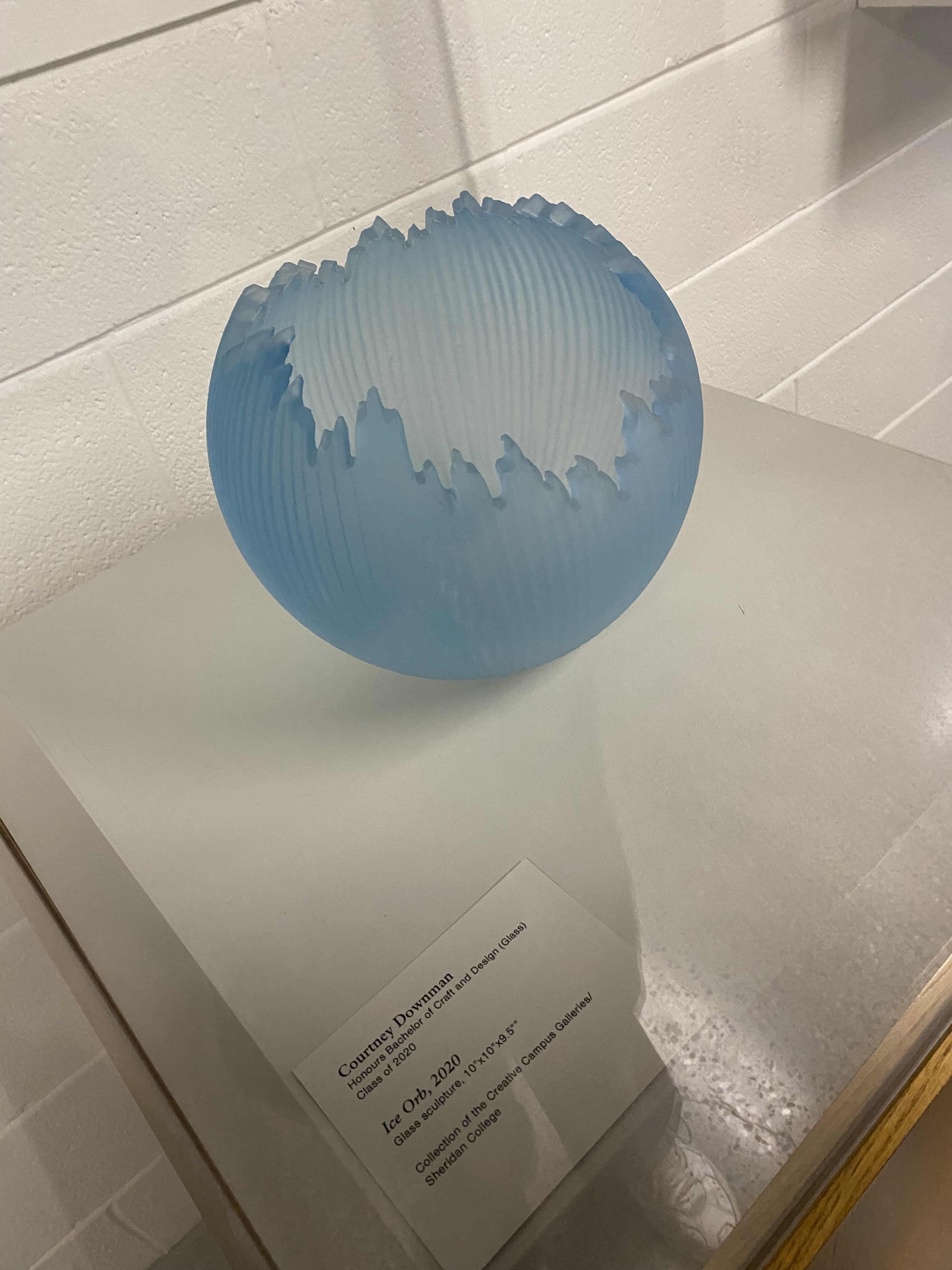This is a spherical display made of glass. It has a light blue surface with wave like shapes.<p>Project Video Link</p></a>